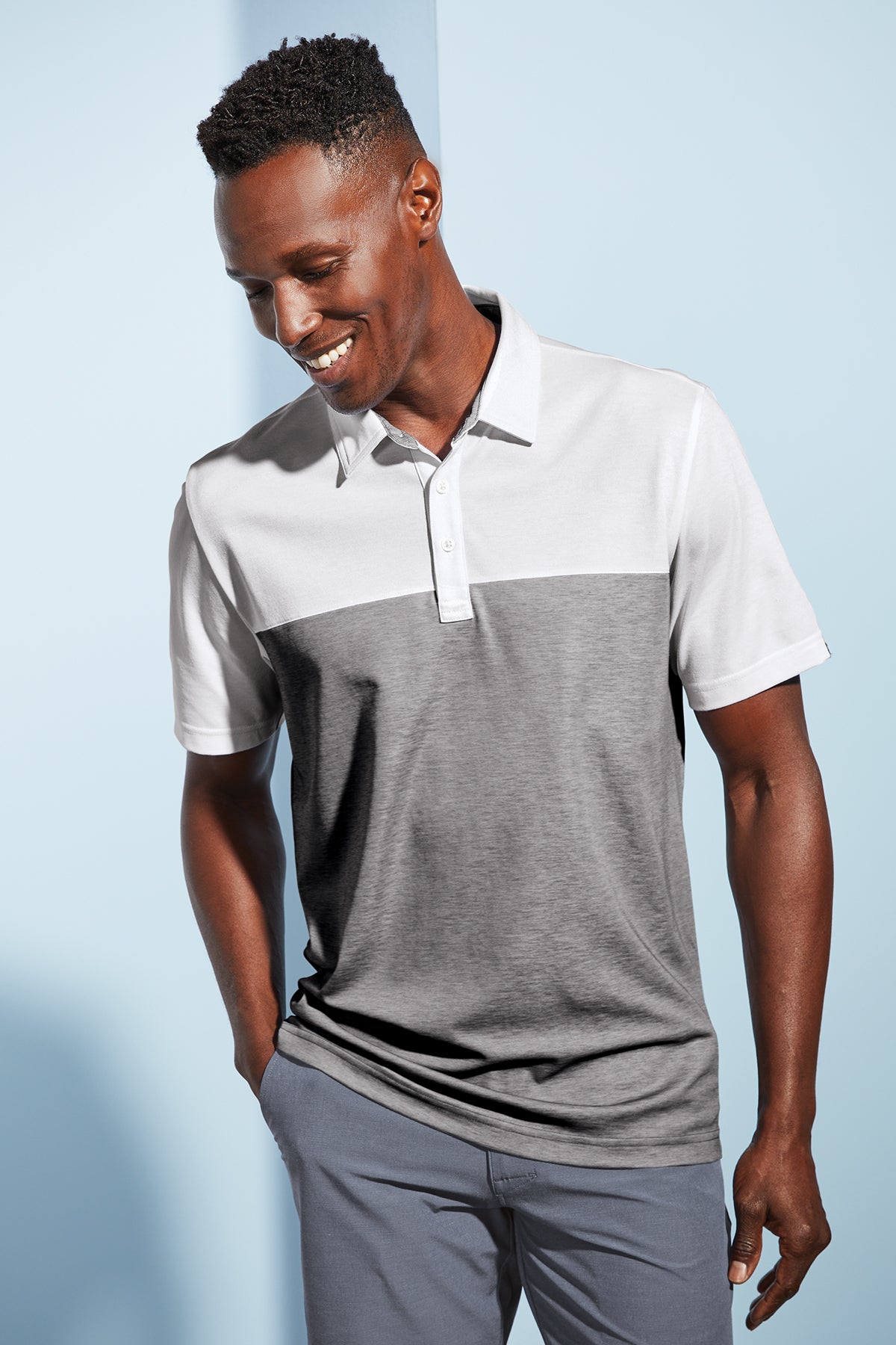 TravisMathew Oceanside Blocked Polo in White/ Quiet Shade Grey Heather, view on model