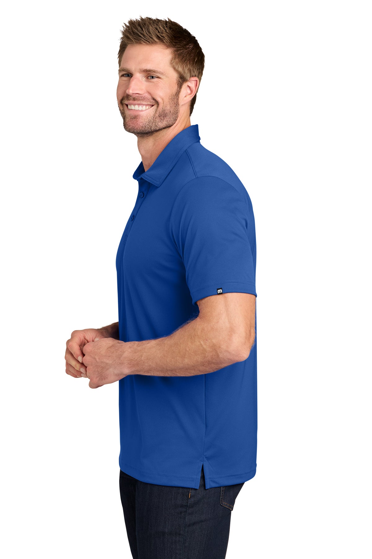 TravisMathew Coto Performance Polo in Royal Blue, side on model