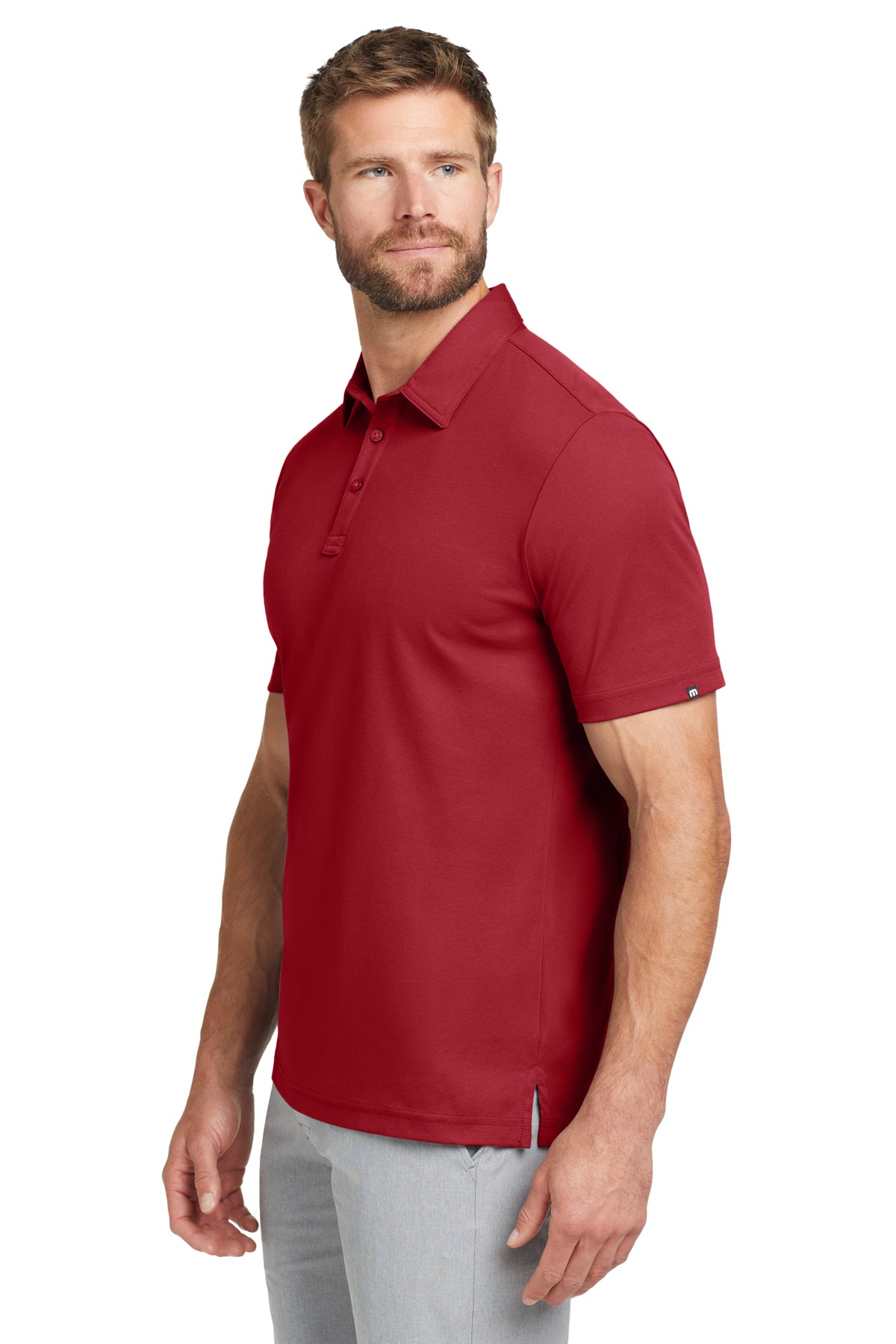 TravisMathew Oceanside Solid Polo in Scooter Red, side on model