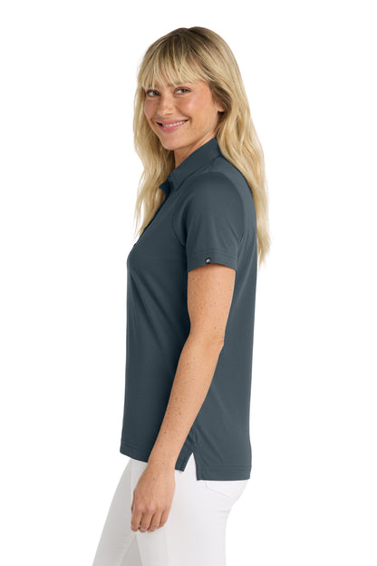 TravisMathew Women's Oceanside Solid Polo in Blue Nights, side on model