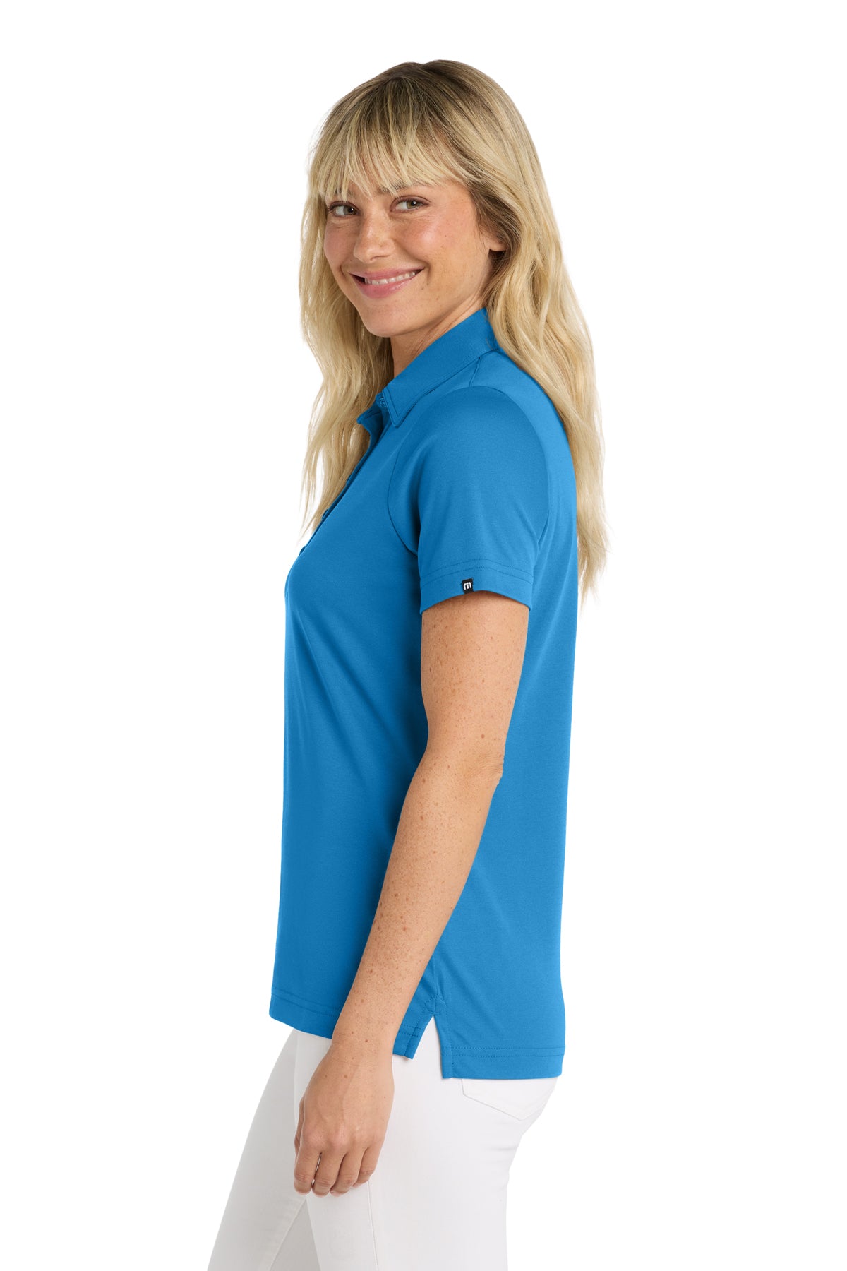 TravisMathew Women's Oceanside Solid Polo in Classic Blue, side on model