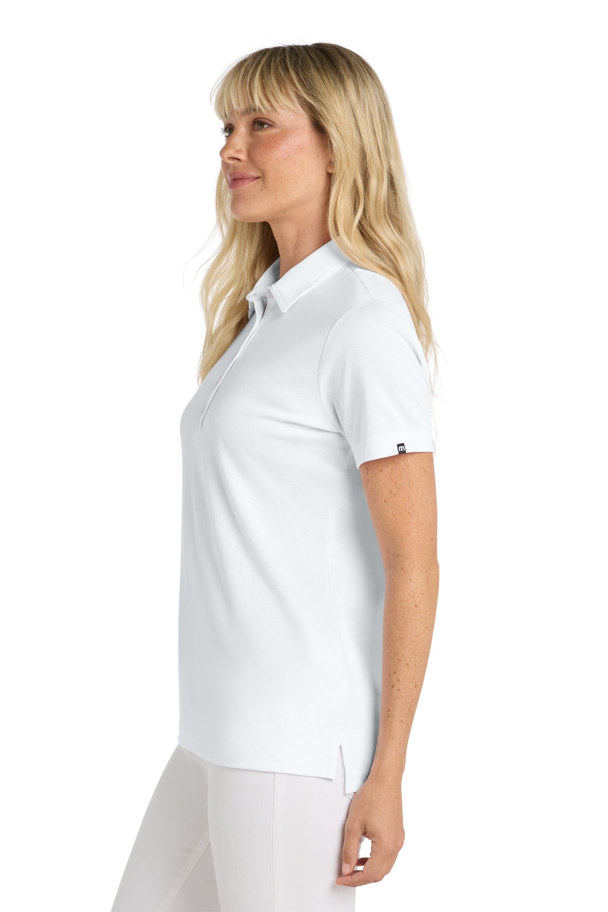 TravisMathew Women's Oceanside Solid Polo in White, side on model