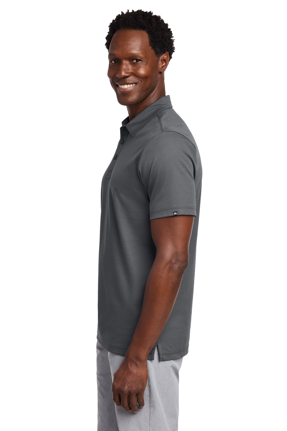 TravisMathew Bayfront Solid Polo in Dark Grey, side on model