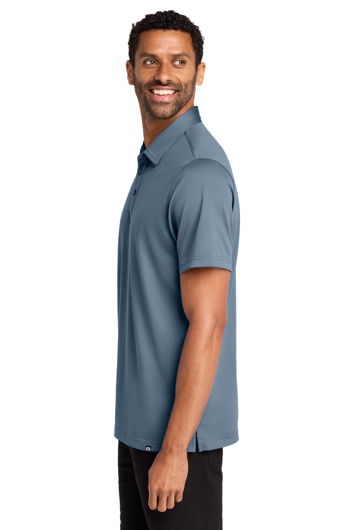 TravisMathew Cabana Solid Polo in Light Denim Blue, side on model
