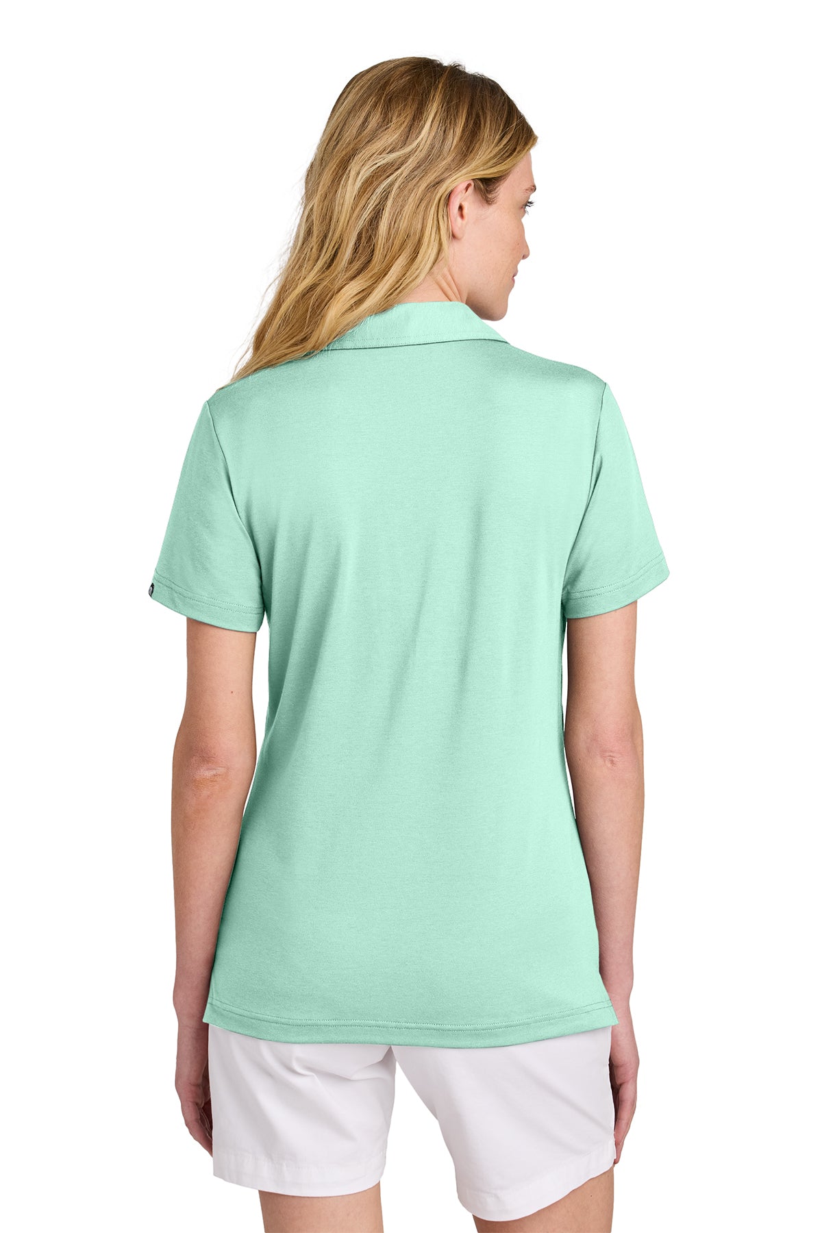 TravisMathew Women’s Glenview Solid Polo in Mint, back on model