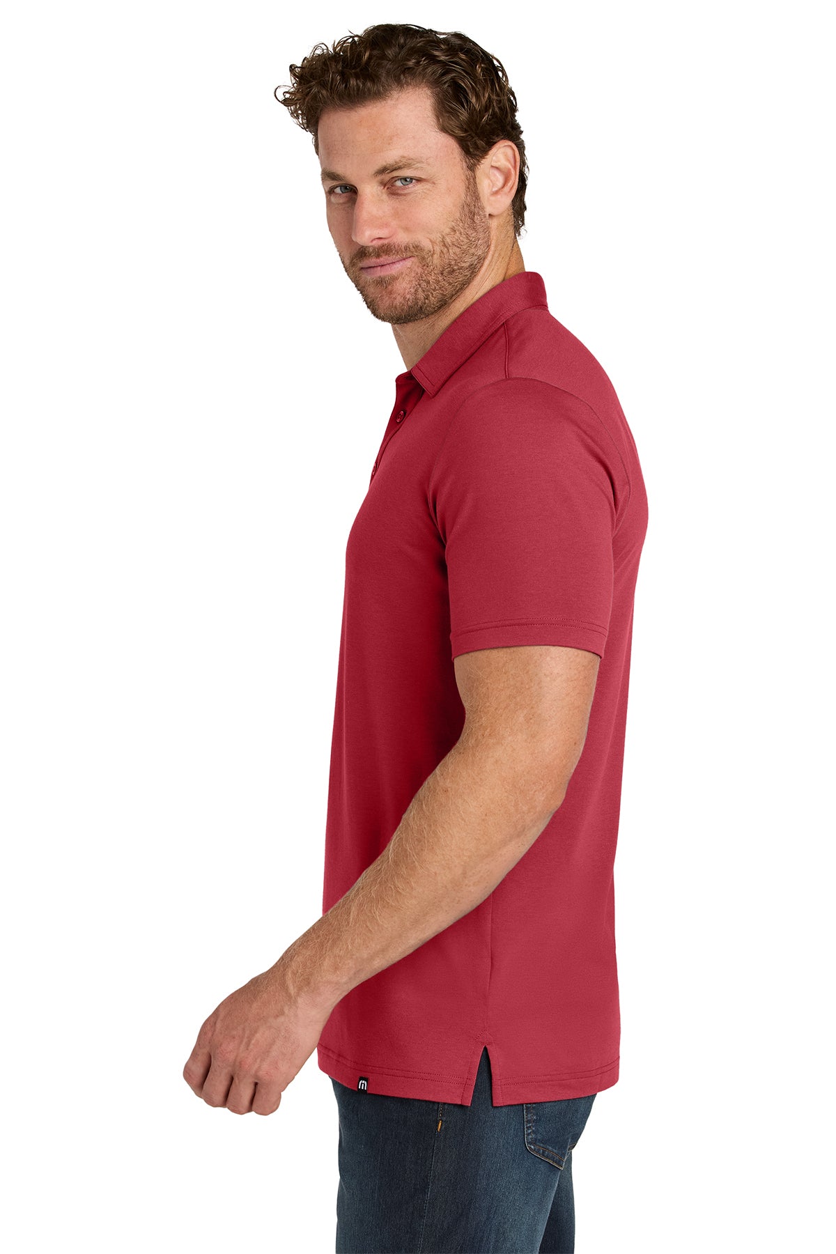 TravisMathew Glenview Solid Polo in Scooter Red, side on model
