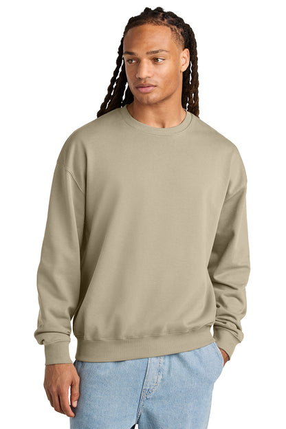 Stanley/Stella Unisex Ledger Dry Crewneck Sweatshirt in Desert Dust, front on model
