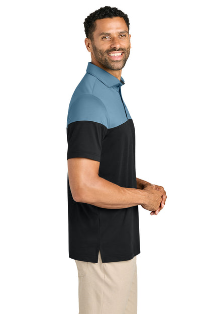 TravisMathew Onward Colorblock Polo in Copen Blue/ Black, side on model