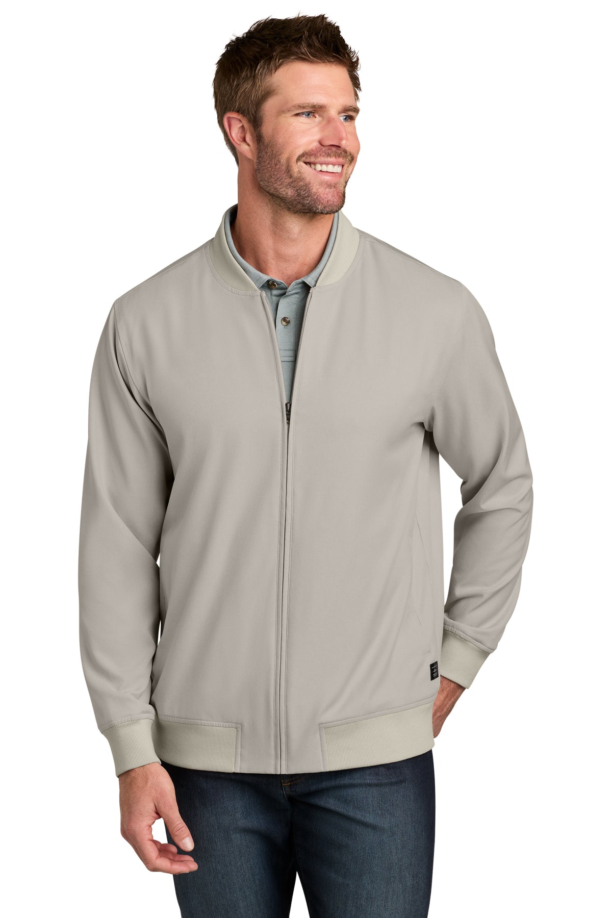 TravisMathew Bomber Jacket in Italian Sand, front on model