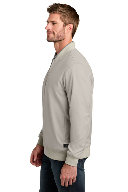 TravisMathew Bomber Jacket in Italian Sand, side on model