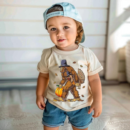 Kids Bigfoot Shirt | Bigfoot Carrying Pumpkin and Turkey Graphic Tee | Funny Fall Shirt for Kids | Thanksgiving Bigfoot Tee