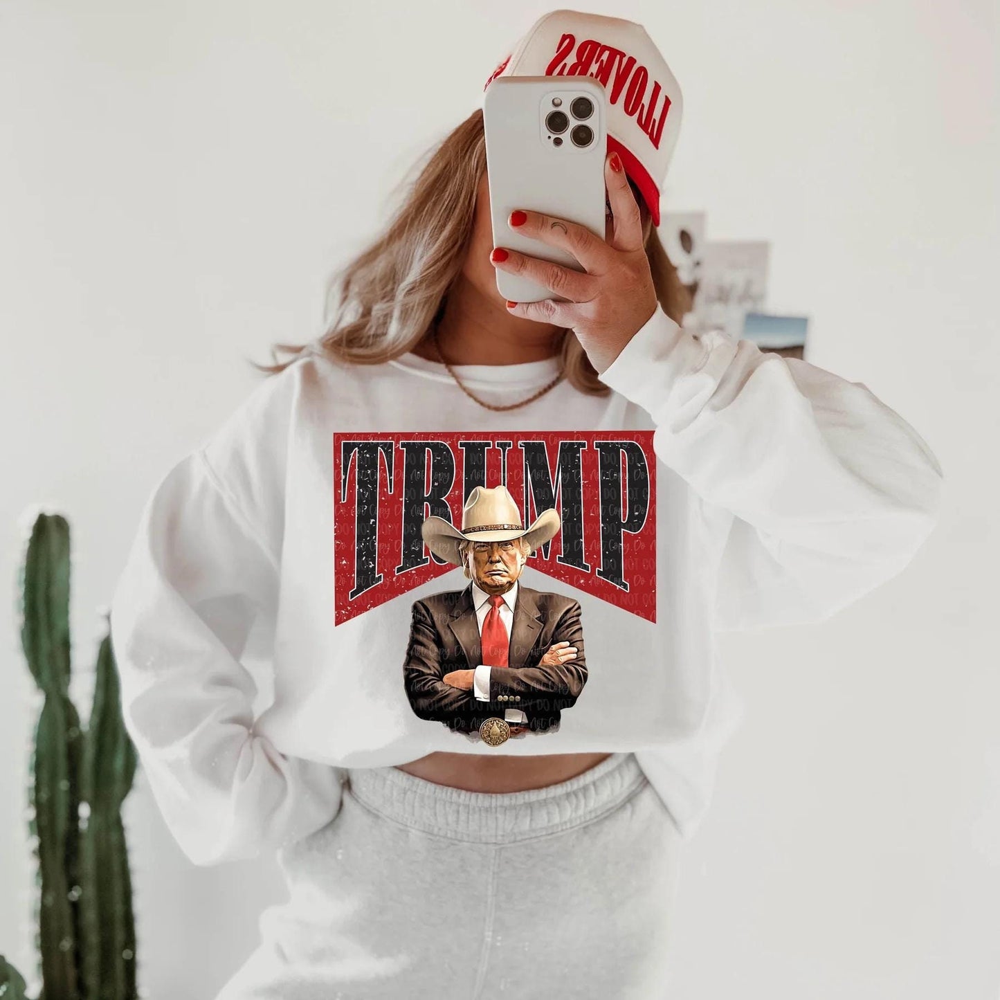 Cowboy Trump Graphic Shirt – Bold ‘TRUMP’ Background Design, T-shirt, Sweatshirt, Hoodie